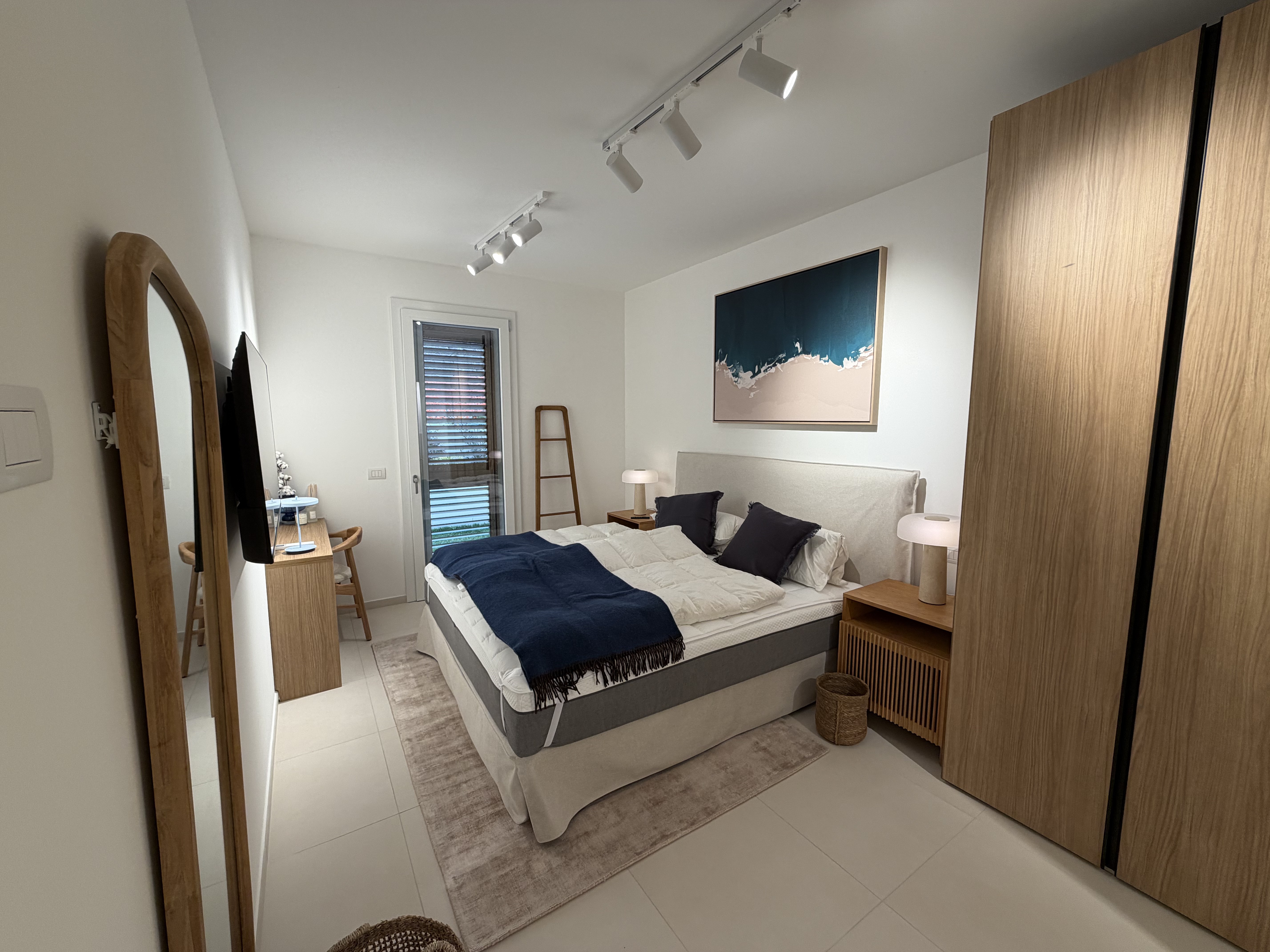 Master bedroom with double bed and designer lighting