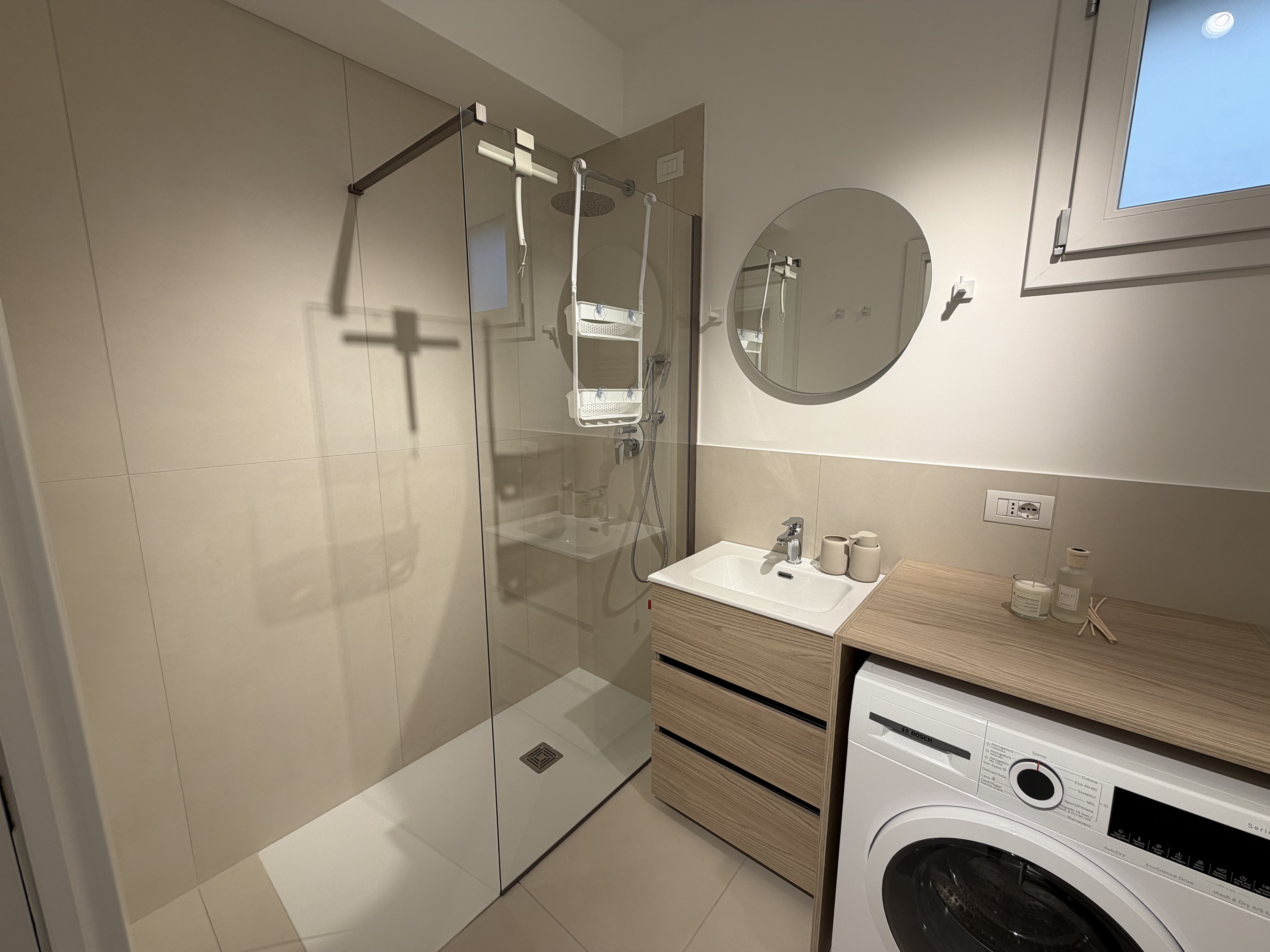 Bathroom with walk-in shower and washing machine