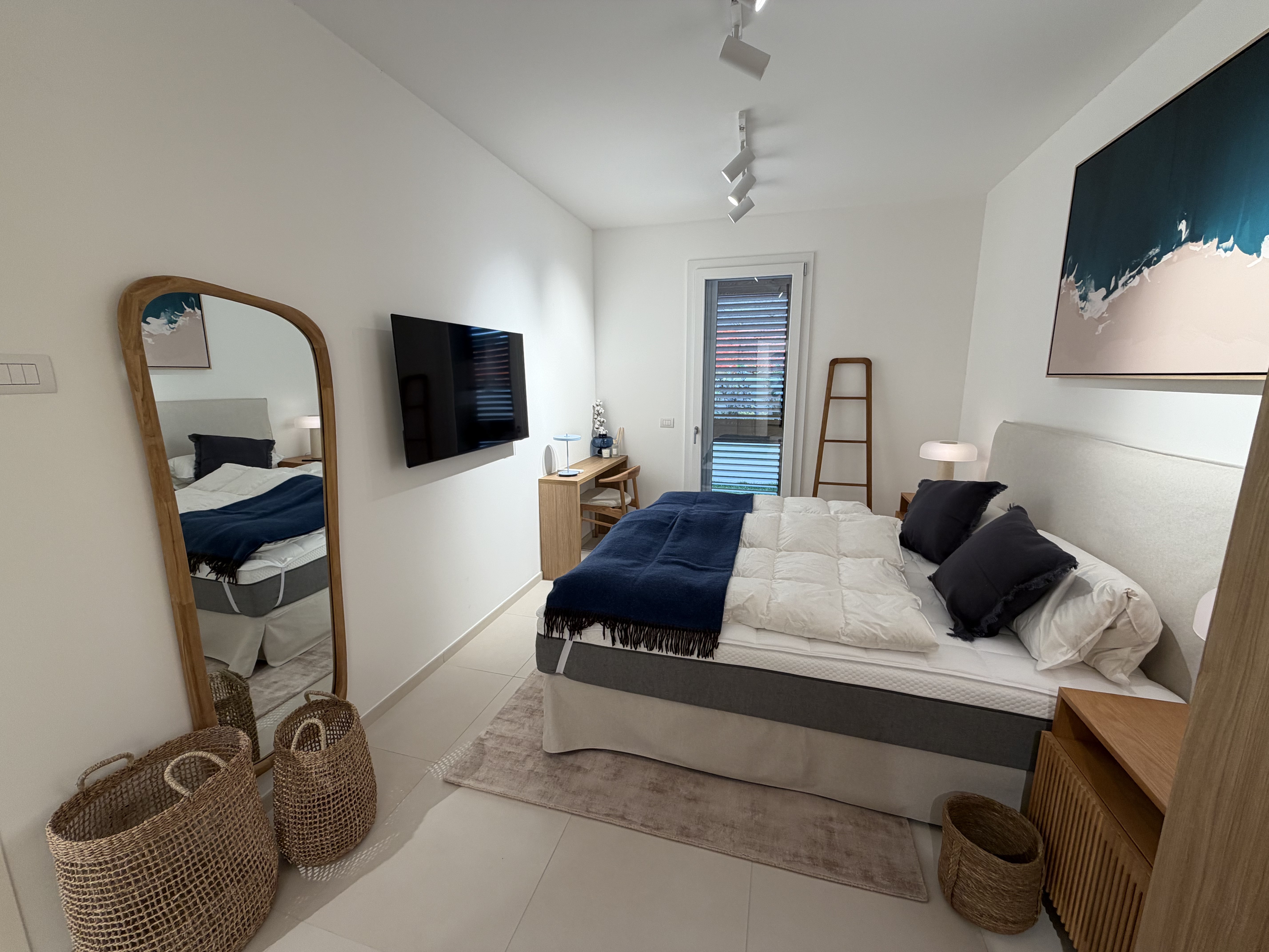 Bedroom with large mirror and wall panelling