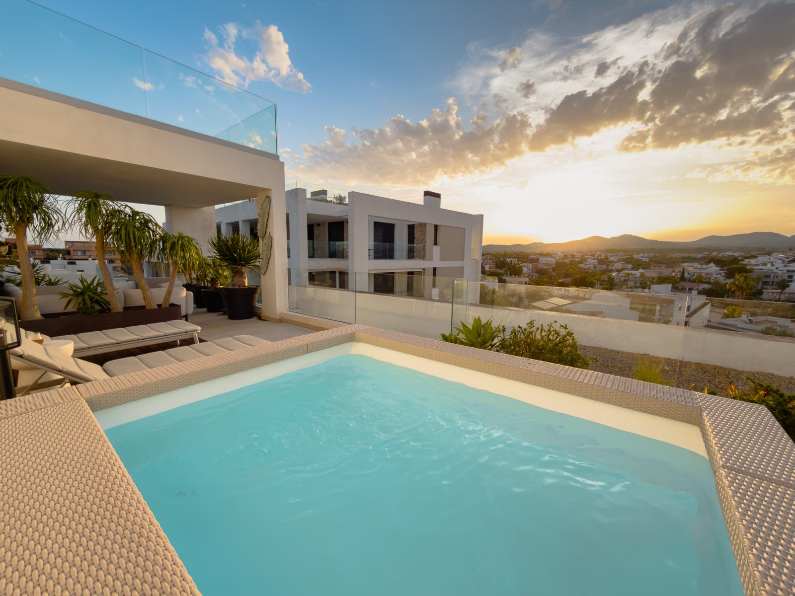 Private rooftop terrace with pool at sunset