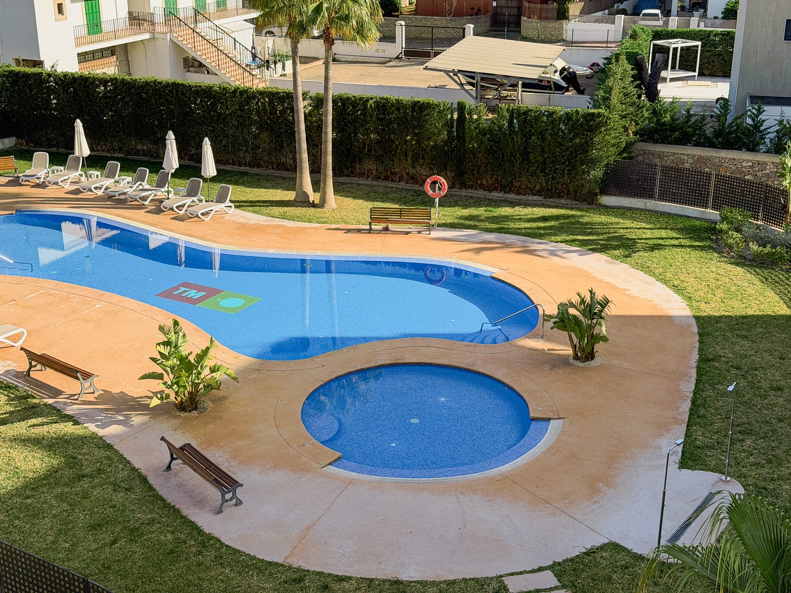 Communal swimming pool with sun loungers