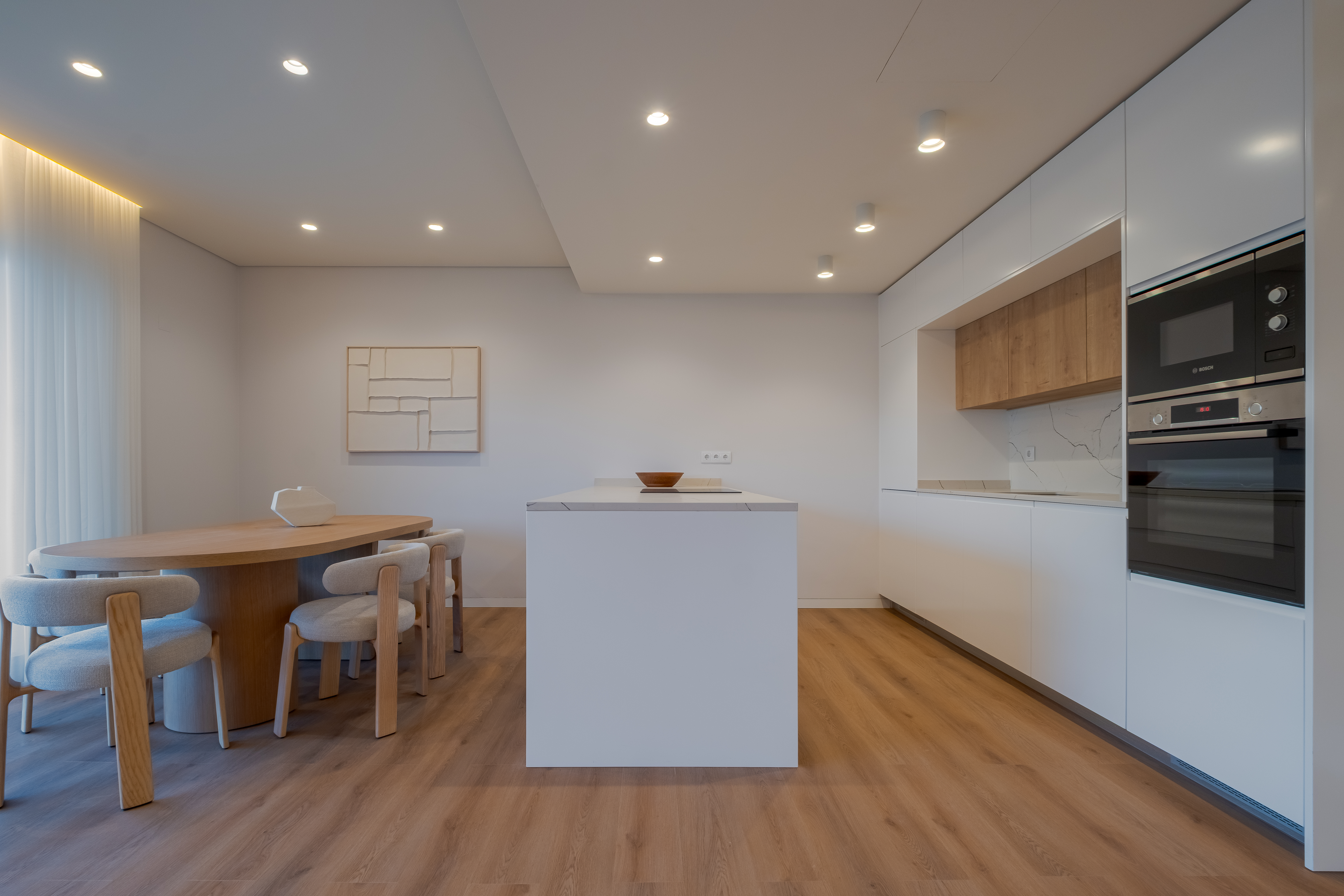 Dining area next to a bright kitchen