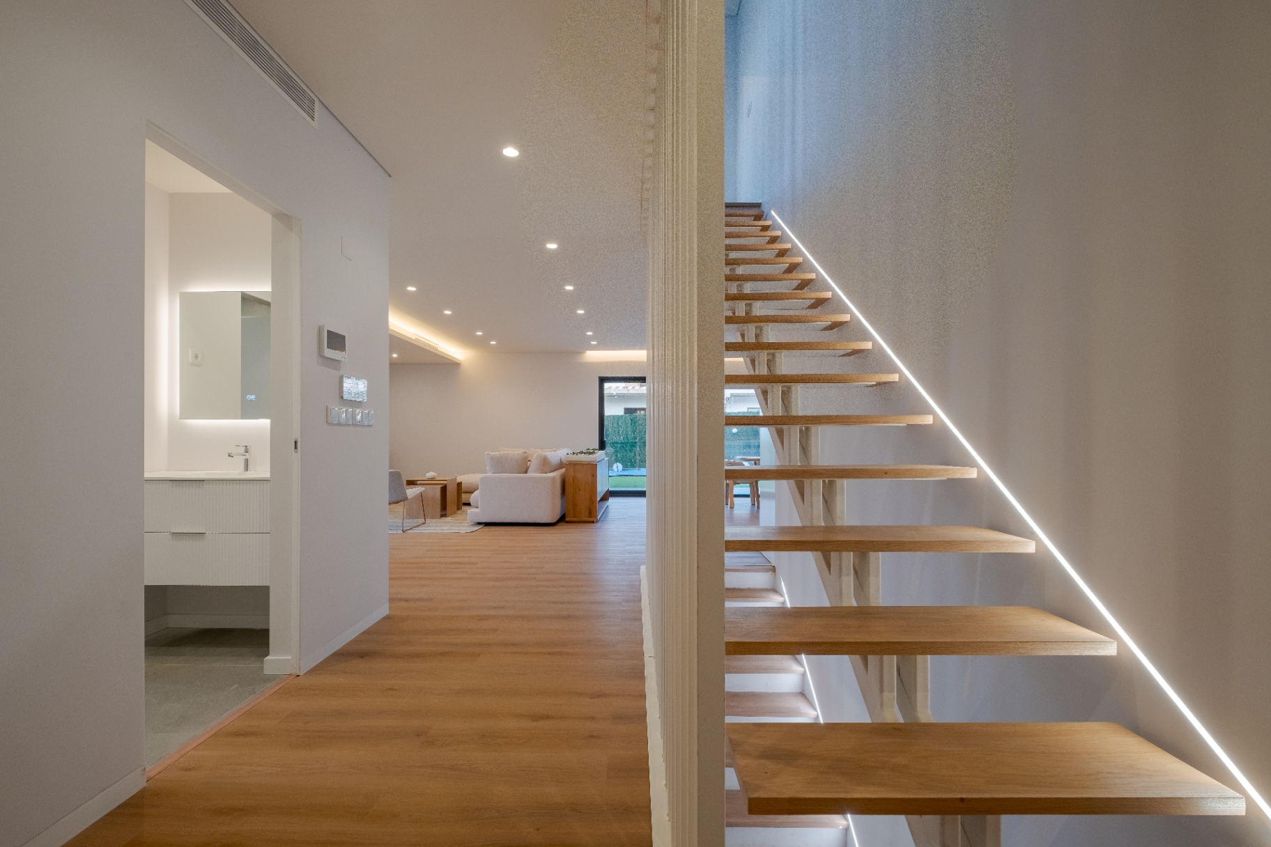Hallway with floating oak staircase
