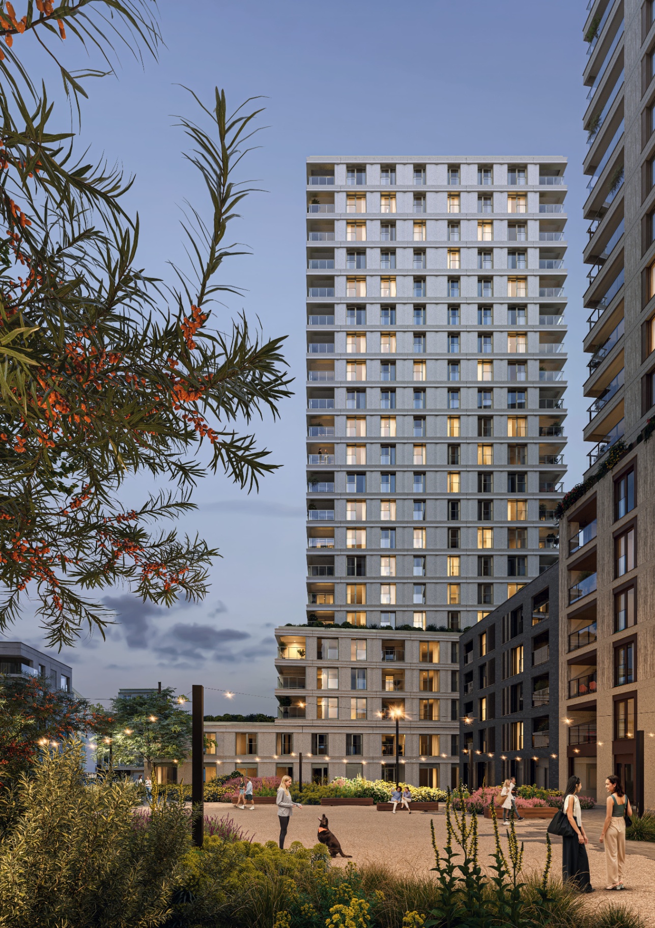 O'Sea — toren bij avondschemering met verlichte appartementen, gezien vanuit de groene binnentuin